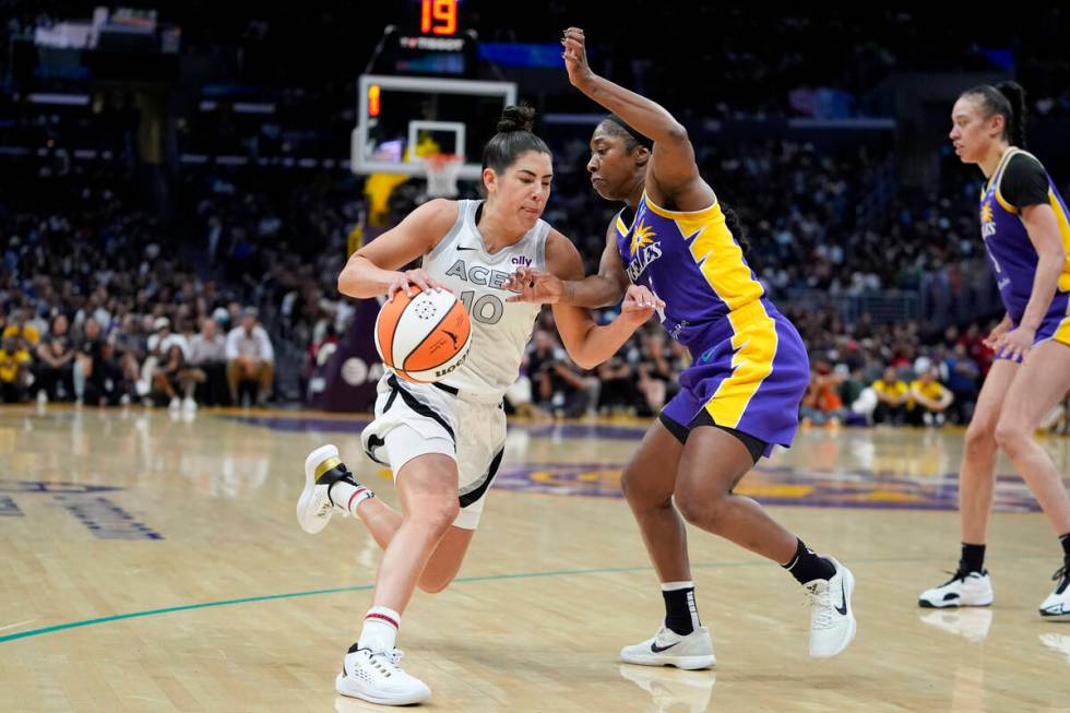 Las Vegas Aces guard Kelsey Plum (10) drives against Los Angeles Sparks guard Aari McDonald dur ...