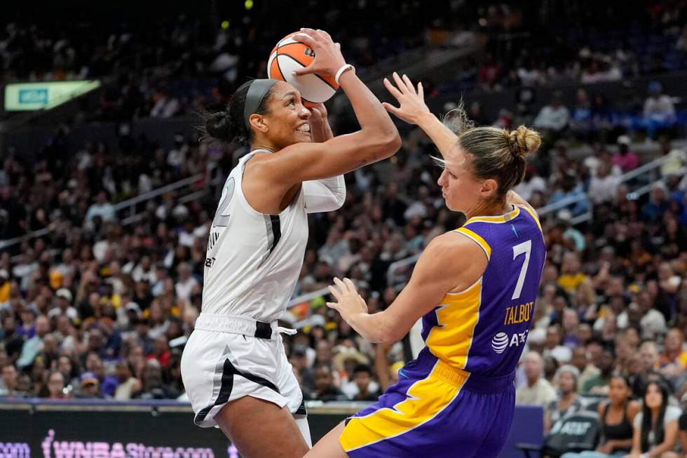 Las Vegas Aces center A'ja Wilson, left, shoots against Los Angeles Sparks forward Stephanie Ta ...