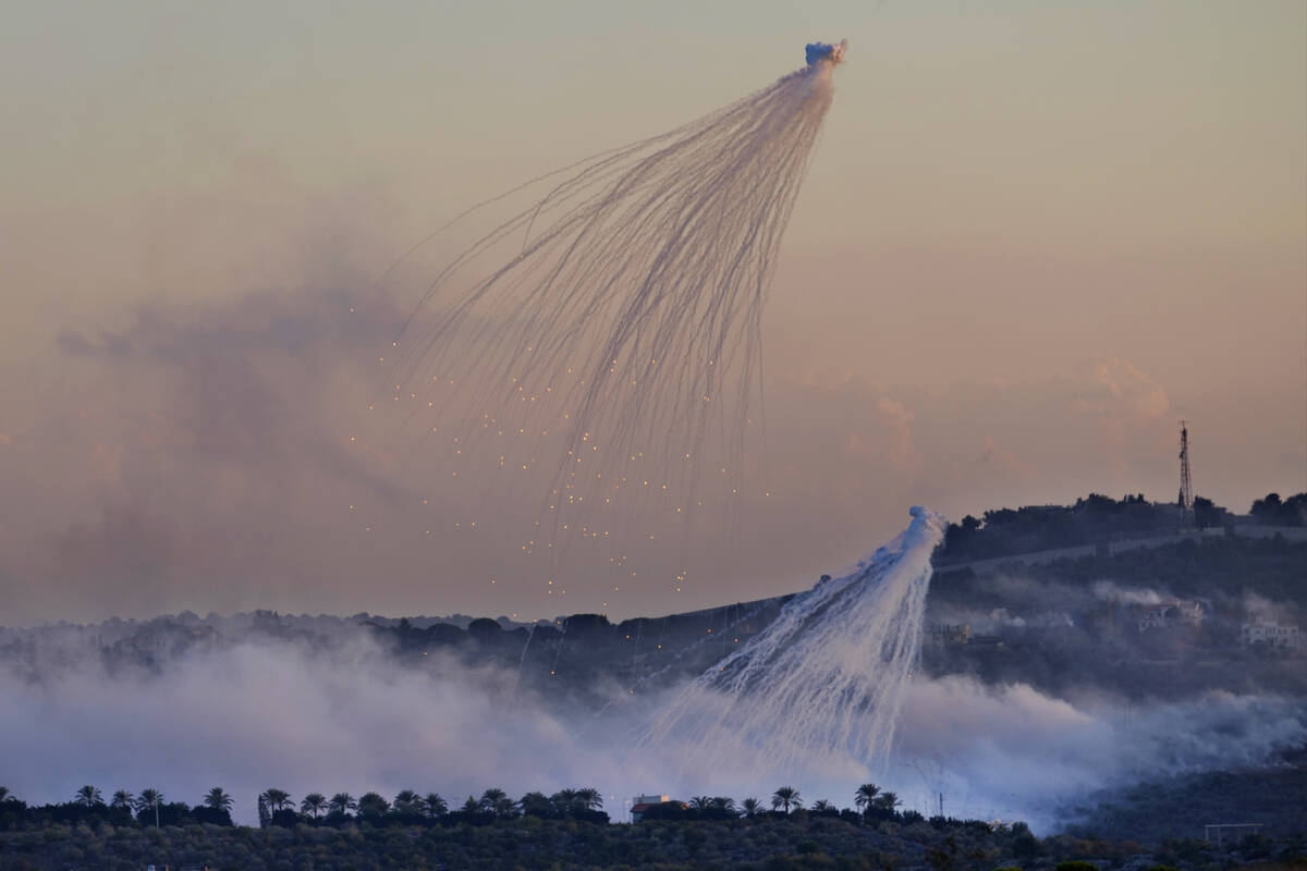 FILE - Shells that appears to be white phosphorus from Israeli artillery explode over Dahaira, ...