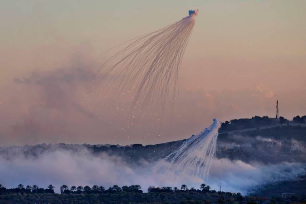 FILE - Shells that appears to be white phosphorus from Israeli artillery explode over Dahaira, ...