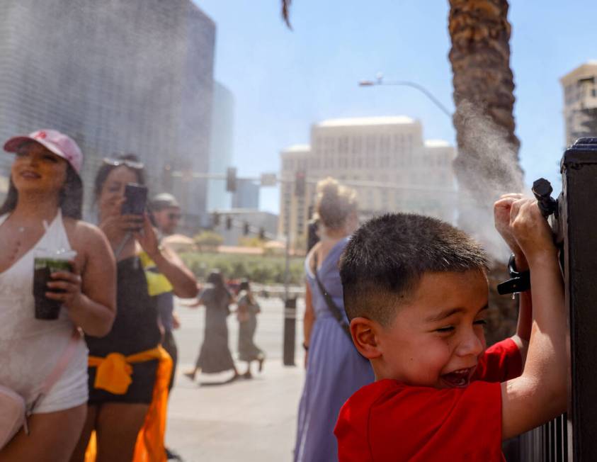 Josiah Ornelas, 6, cools down in front of misters outside Paris Las Vegas hotel-casino, Sunday, ...