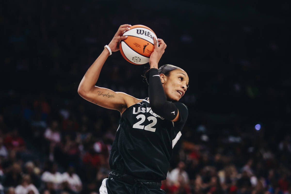 Aces center A'ja Wilson (22) grabs the ball as it comes down from the hoop during a WNBA basket ...