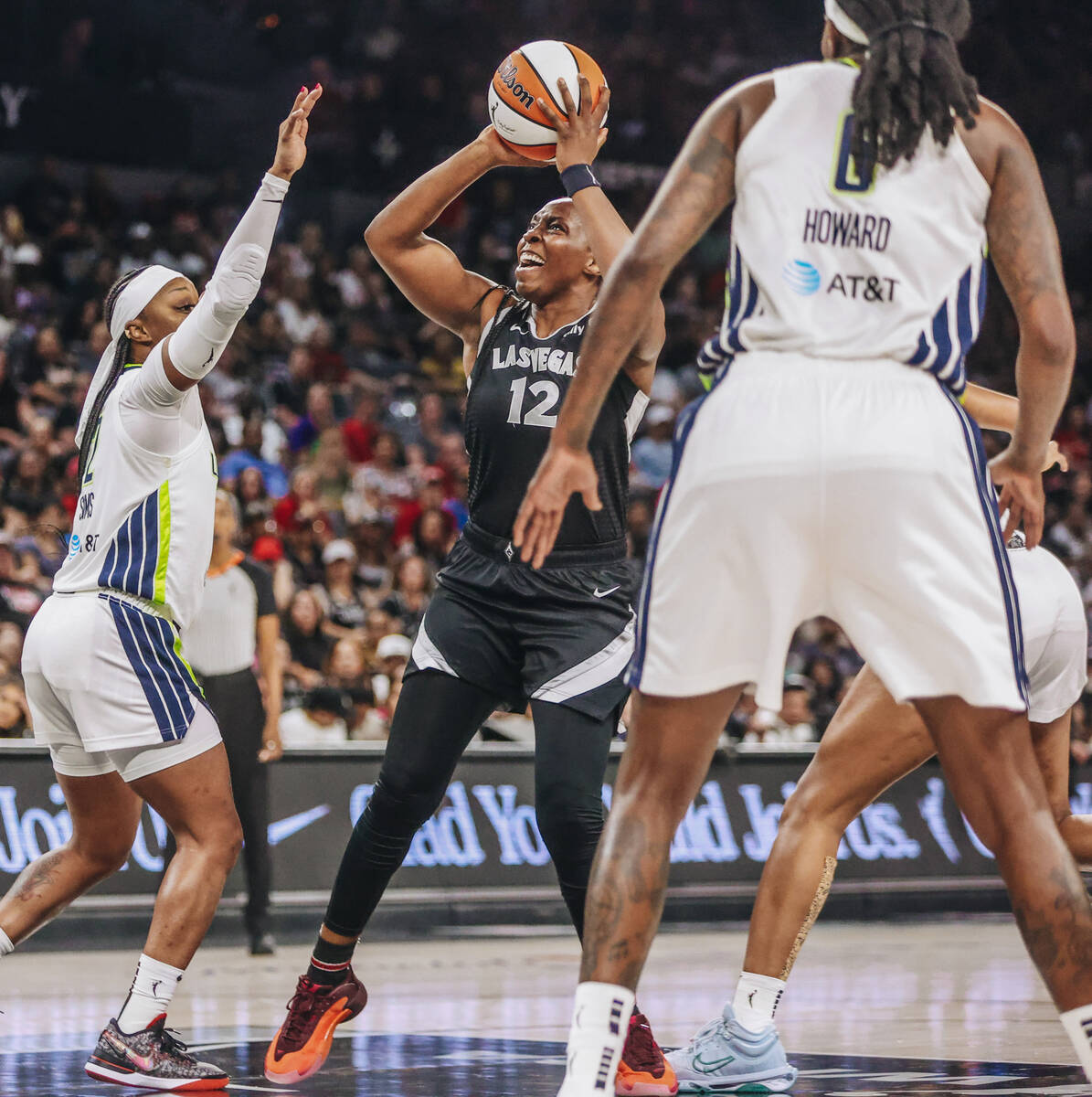 Aces guard Chelsea Gray (12) works to make a basket during a WNBA basketball game between the A ...