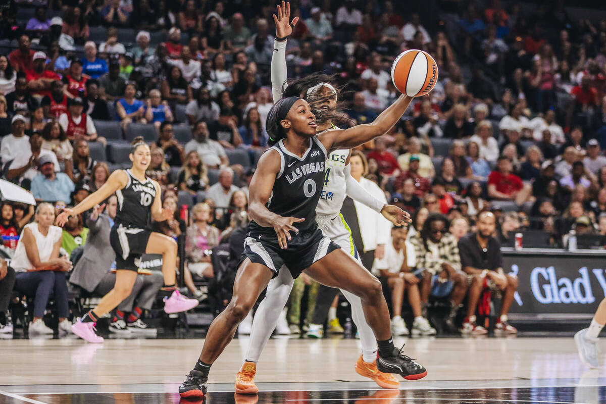 Aces guard Jackie Young (0) chases the ball during a WNBA basketball game between the Aces and ...