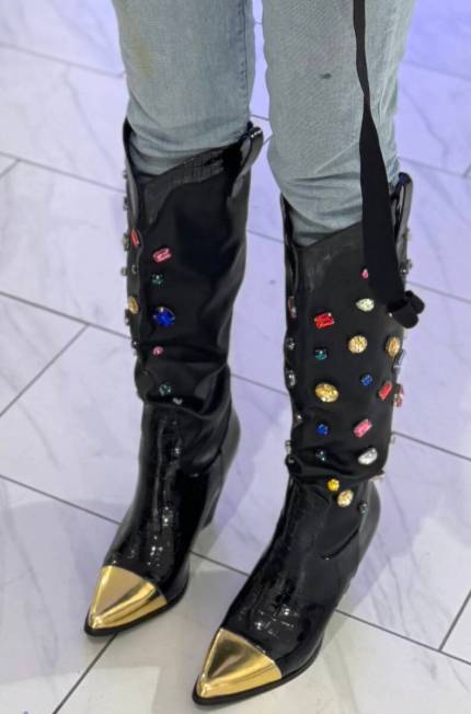 Comic star Whitney Cummings shows off her new Vegas-fashioned boots before taking the stage for ...