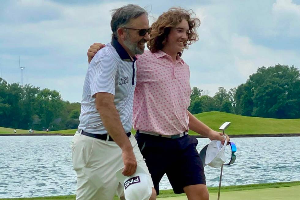 Drake Harvey leaves the 18th green at Crooked Stick with his dad, Billy Harvey, after winning t ...