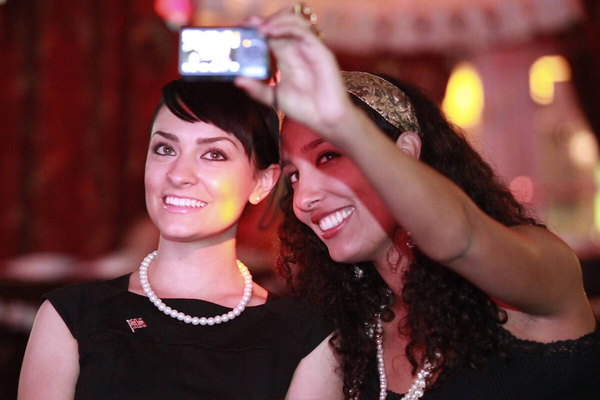 Rebecca Stevens, left, and Aneya Fernando take a self portrait while watching coverage of the r ...