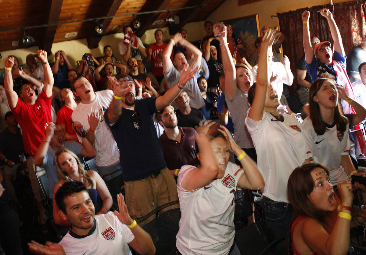 Soccer fans react while watching televised coverage as Team USA misses a shot against Ghana dur ...