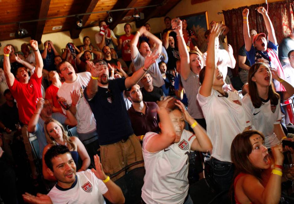 Soccer fans react while watching televised coverage as Team USA misses a shot against Ghana dur ...