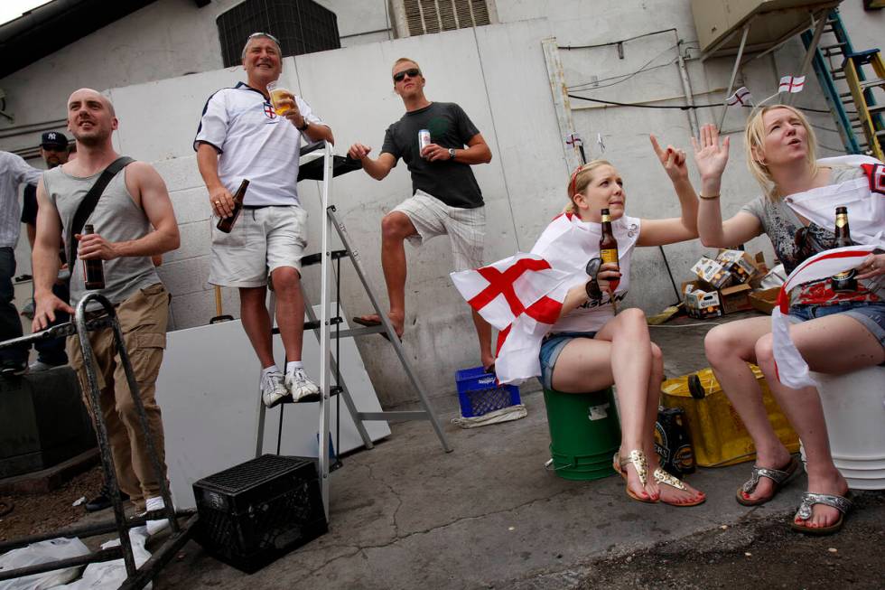 Part of the overflow crowd of soccer fans watch televised World Cup 2010 coverage of a match be ...