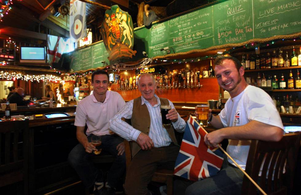 Fans of British boxer Ricky Hatton, George Beard, center, is flanked by his sons Luke, left, an ...