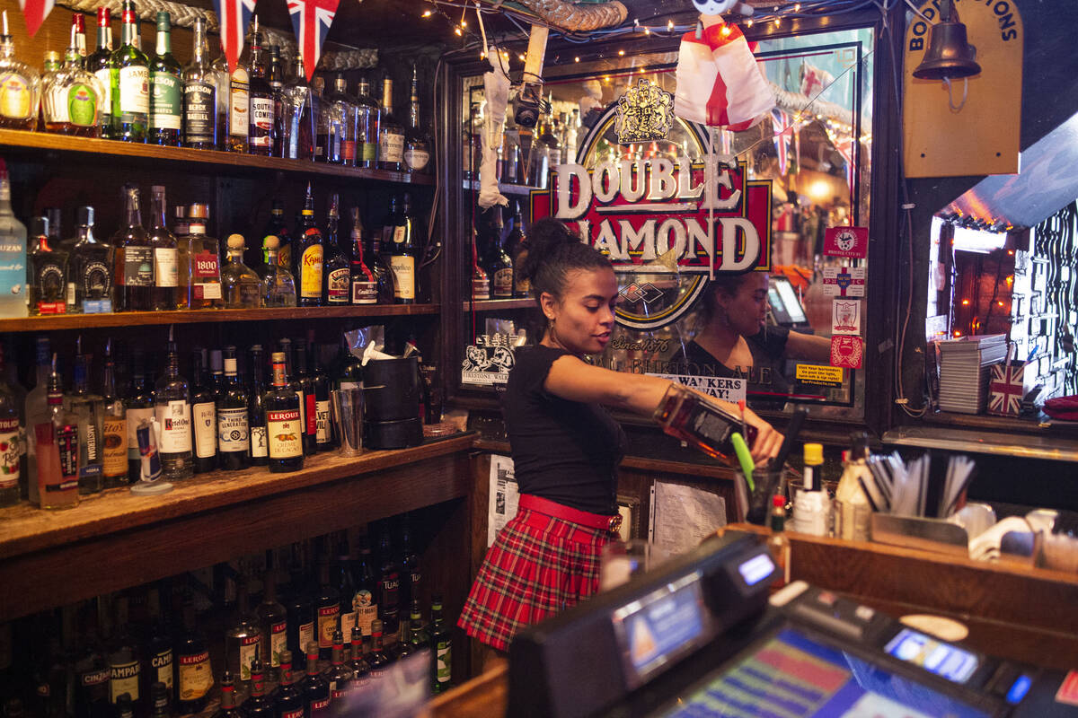 Bartender Lindsey Cruz pours a drink while sharing her experience with the supernatural earlier ...