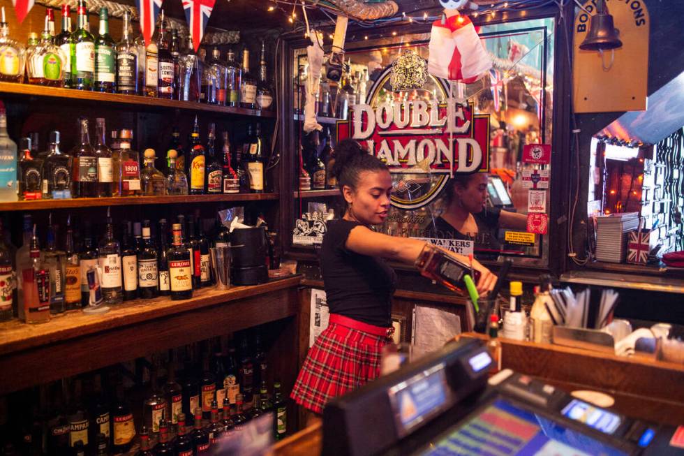 Bartender Lindsey Cruz pours a drink while sharing her experience with the supernatural earlier ...