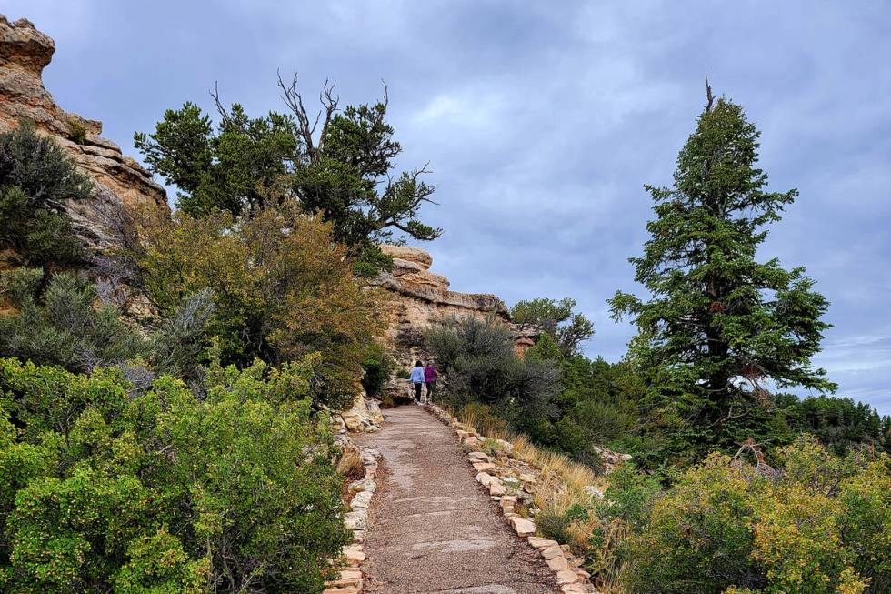Visitors walk along a rim trail near the Grand Canyon Lodge – North Rim. (Natalie Burt)