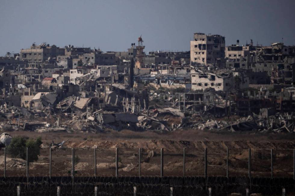 Destroyed buildings stand in the Gaza Strip, as seen from southern Israel, Monday, July 8, 2024 ...