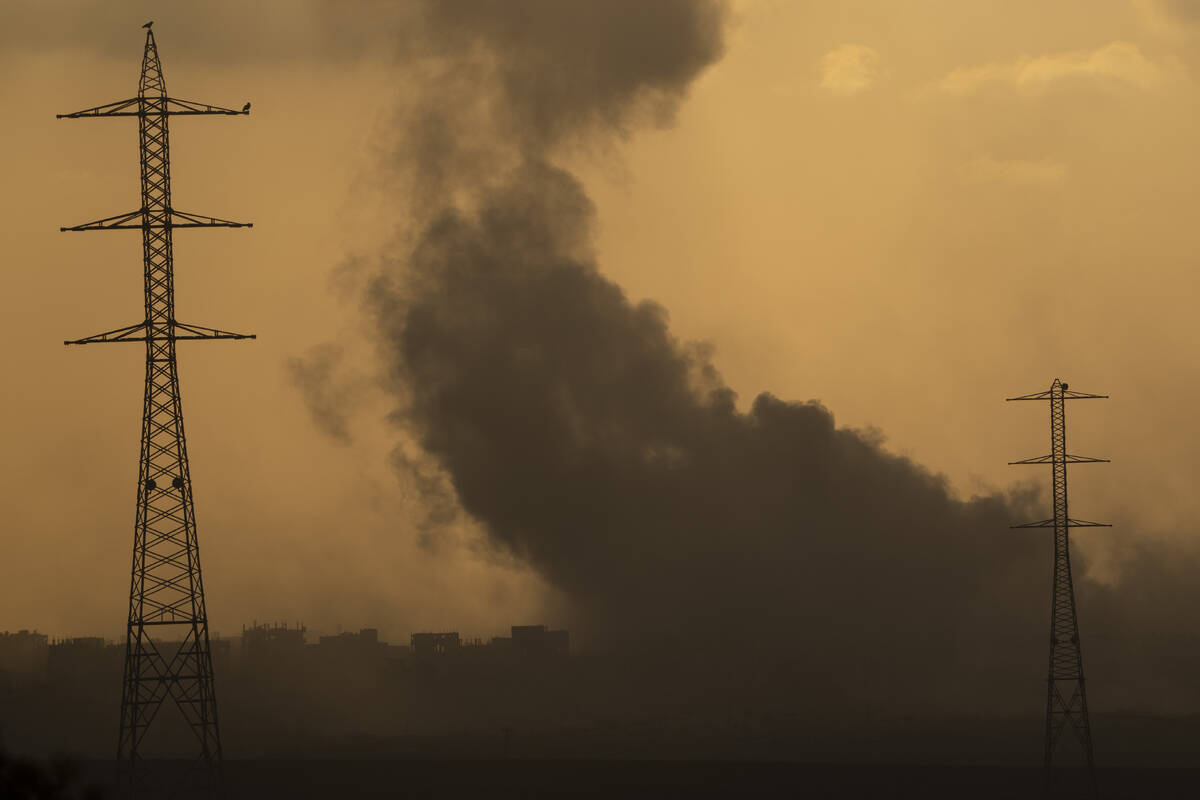 Smoke rises to the sky after an explosion in the Gaza Strip as seen from southern Israel, Monda ...