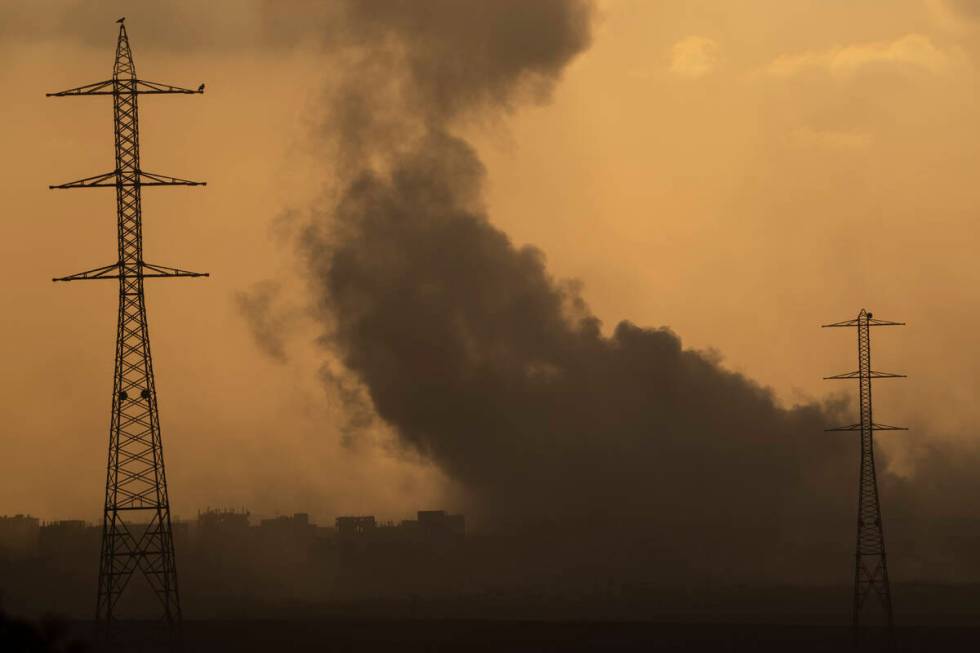 Smoke rises to the sky after an explosion in the Gaza Strip as seen from southern Israel, Monda ...