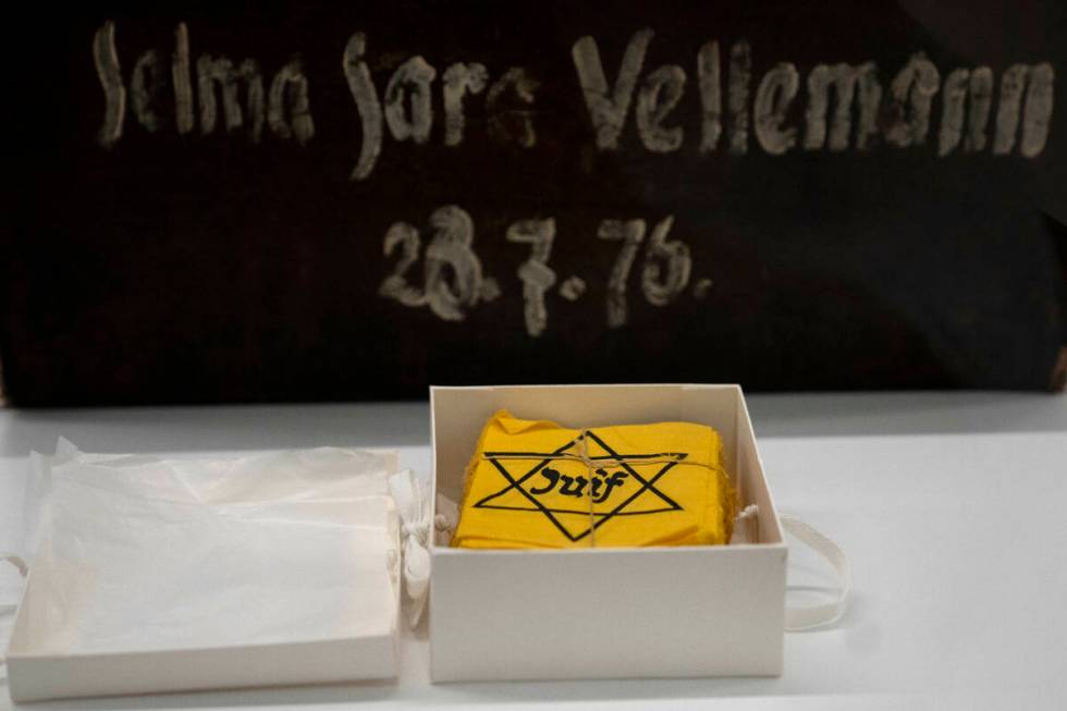 Yellow badges and a piece of luggage are displayed during the inauguration of The Moshal Shoah ...