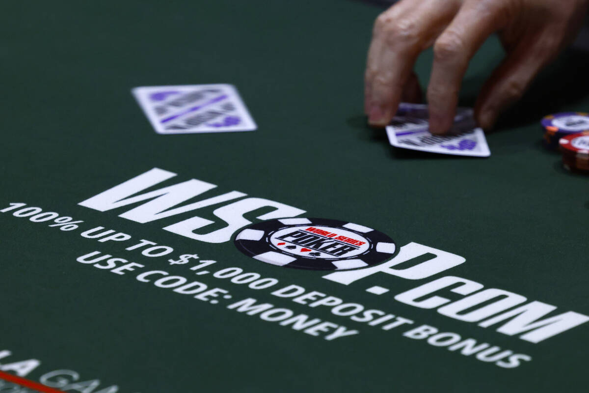 A poker player participates during the first day of the World Series of Poker Main Event at Hor ...