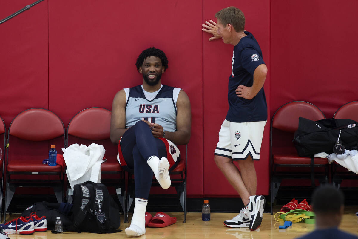 Philadelphia 76ers center Joel Embiid, left, chats with USA Basketball Men’s National Te ...