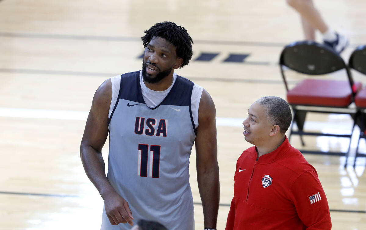 Joel Embiid, left, of the Philadelphia 76ers, talks with United States men's basketball assista ...