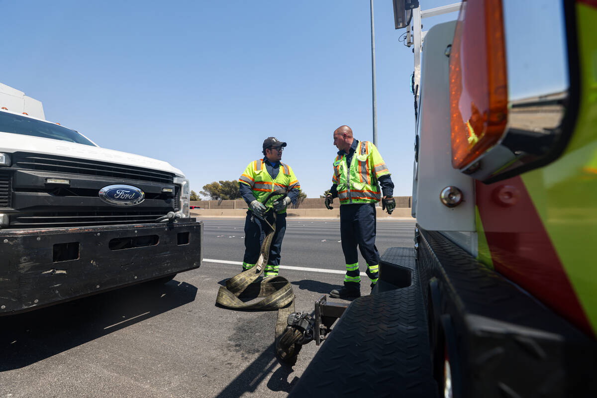 Stephen SanFilippo, supervisor for the Freeway Service Patrol, right, helps out his patrol ...