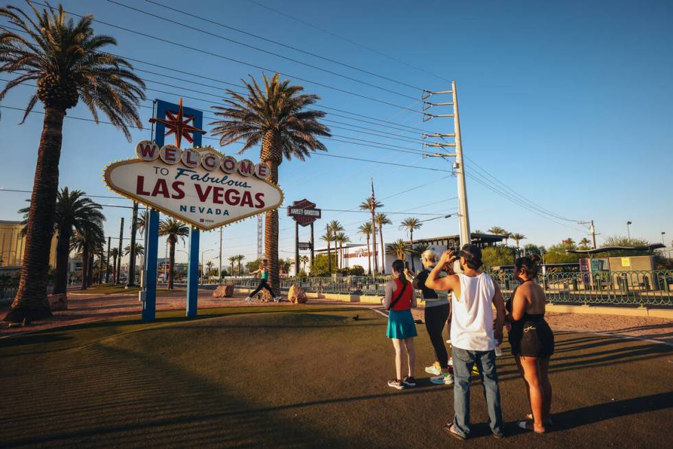 Tourists line up to take photographs at the “Welcome to Fabulous Las Vegas” sign ...