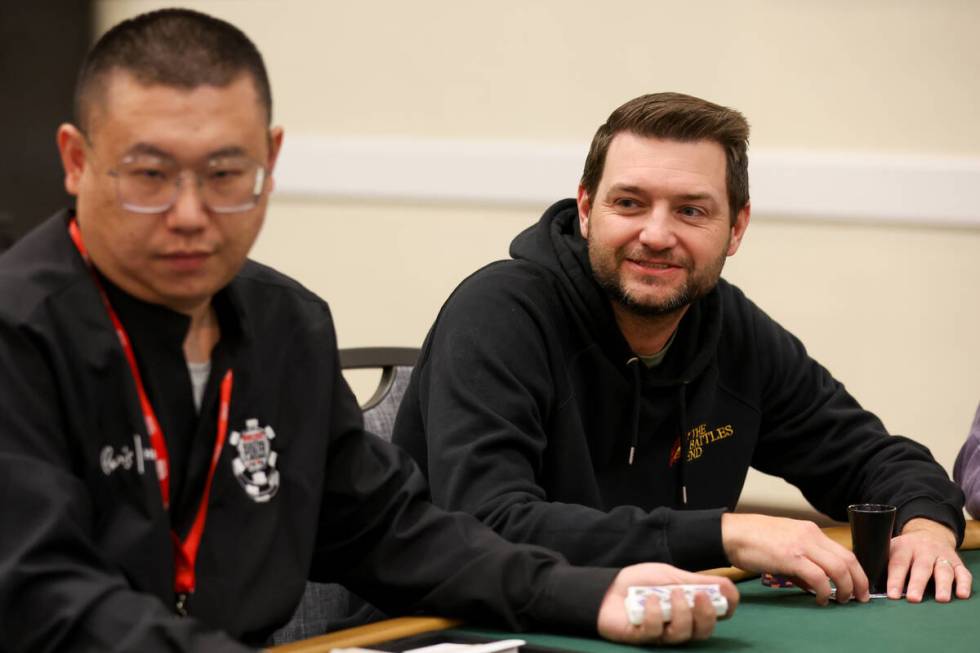 Josh Reichard, right, smiles at the table during the World Series of Poker main event at Horses ...