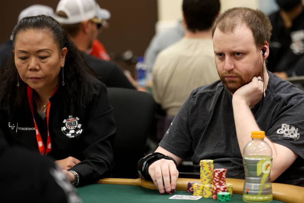 Joe McKeehan, right, focuses at the table during the World Series of Poker main event at Horses ...