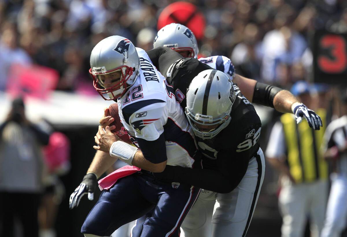 Oakland Raiders defensive tackle Richard Seymour (92) tackles New England Patriots quarterback ...