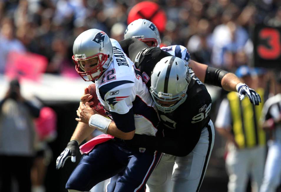 Oakland Raiders defensive tackle Richard Seymour (92) tackles New England Patriots quarterback ...