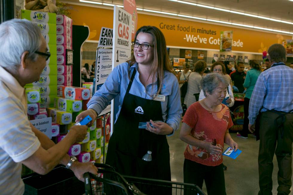 Customer service manager Cathy Budginas greets patrons as they enter during the grand opening o ...