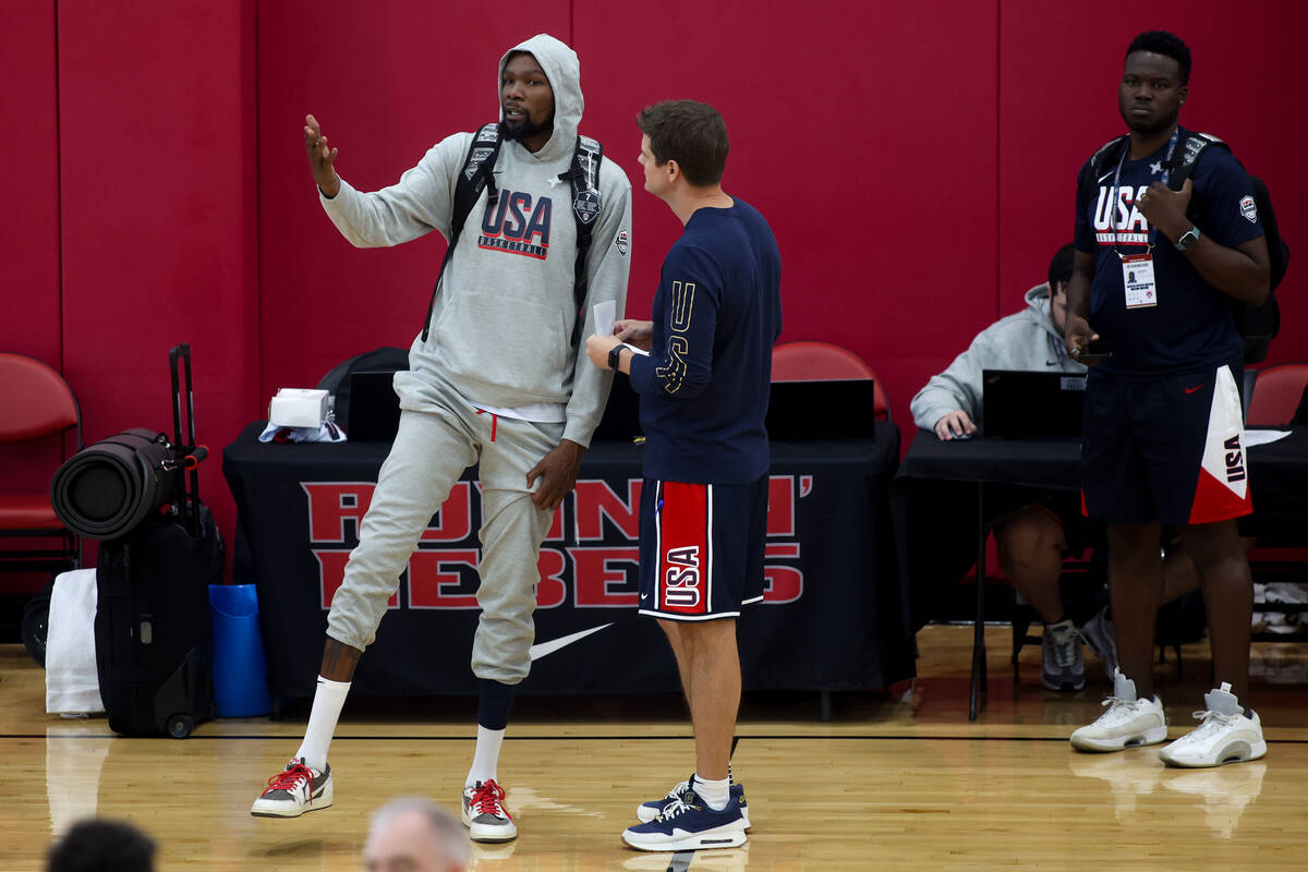 Phoenix Suns forward Kevin Durant, left, chats on the court during training camp for the USA Ba ...