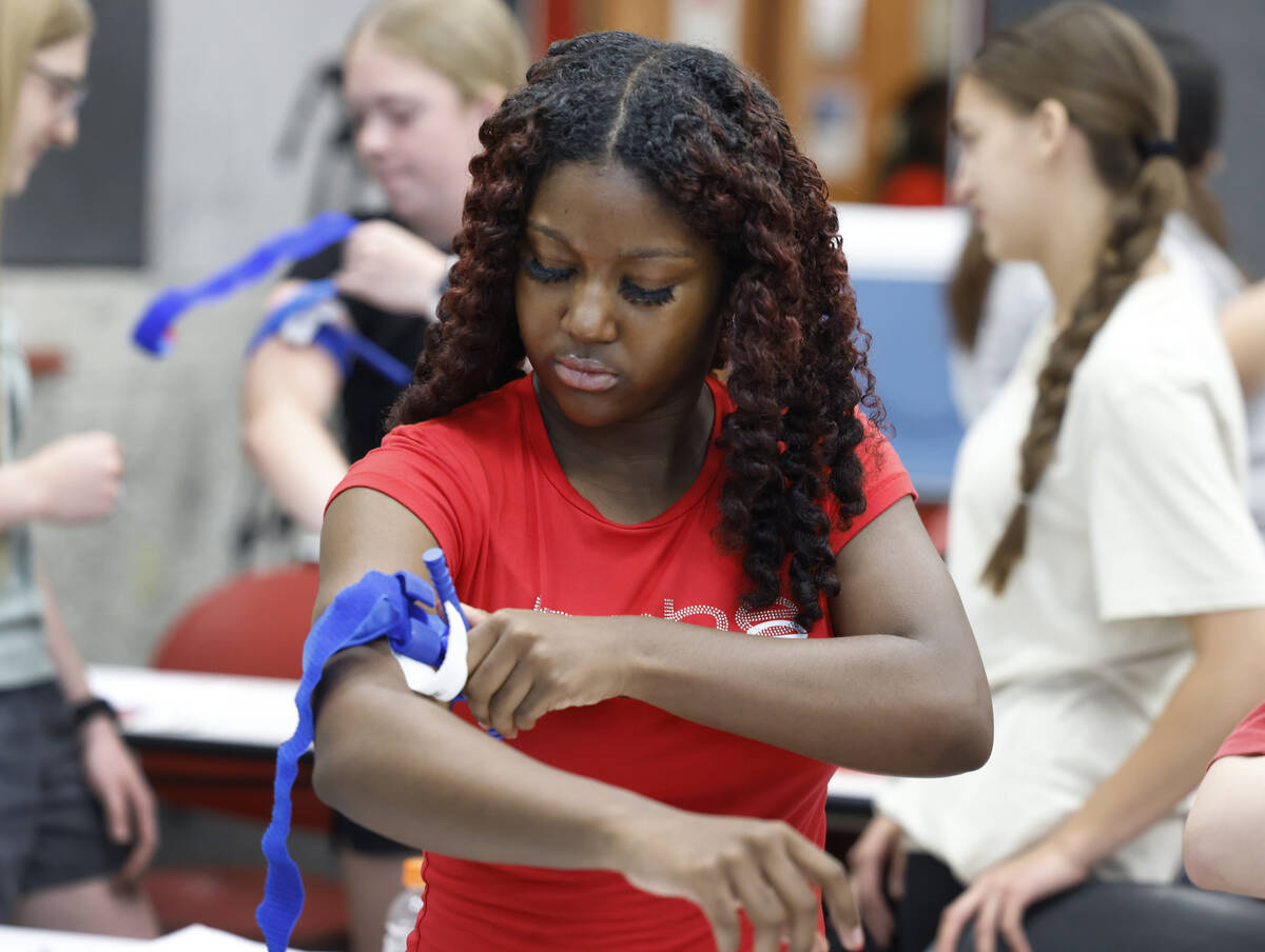 Desert Oasis High School student Shyann Kincaid practices to stop the flow of blood by using to ...