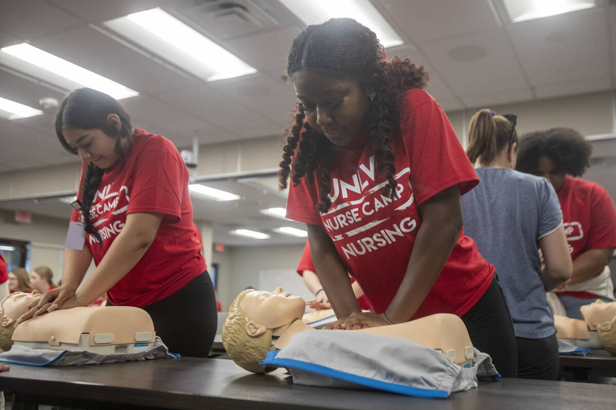Shyann Kincaid, 16, right, practices CPR on a mannequin during UNLV School of Nursing's 5th ann ...