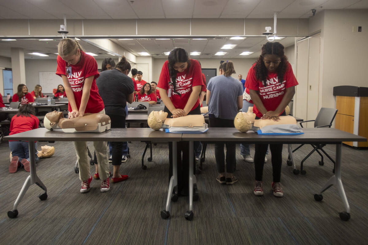 Campers practice CPR on mannequins during UNLV School of Nursing's 5th annual Nurse Camp at the ...