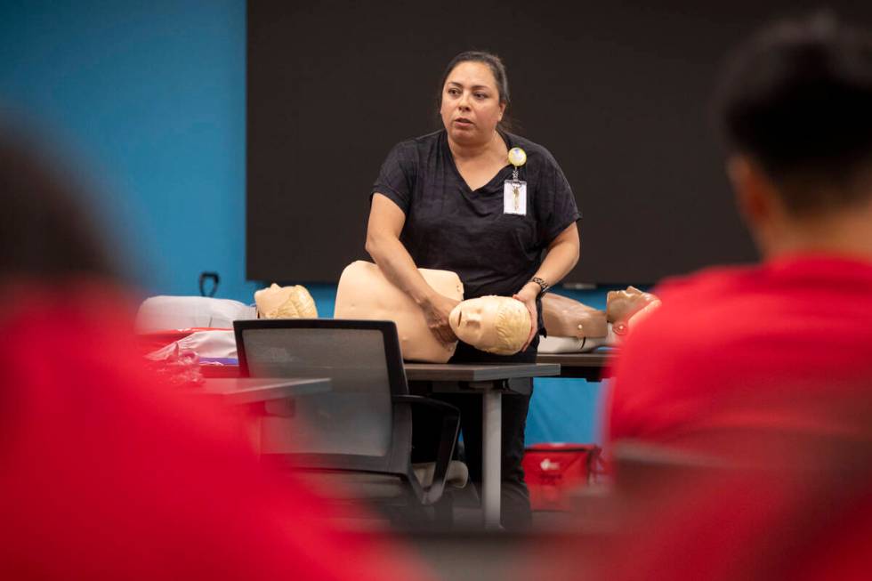R.N. Xochitl Kambak teaches campers how to help someone who is choking during UNLV School of Nu ...
