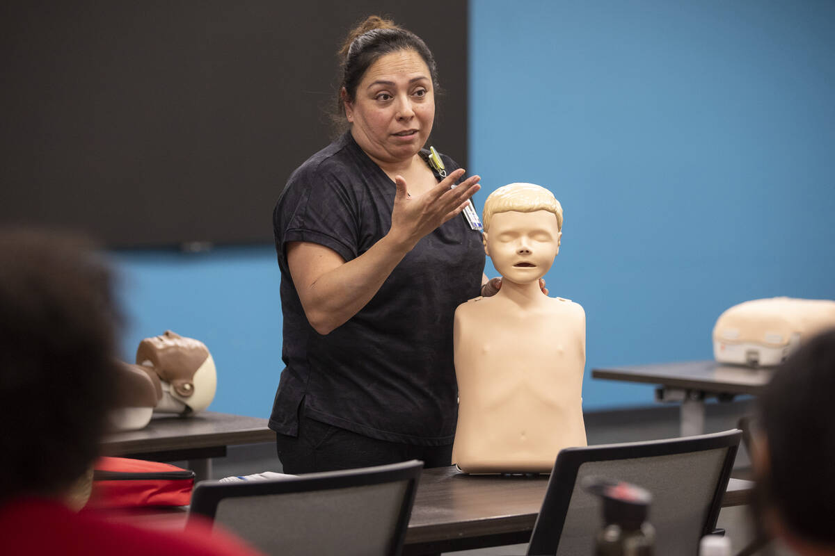 R.N. Xochitl Kambak teaches campers how to perform CPR during UNLV School of Nursing's 5th annu ...