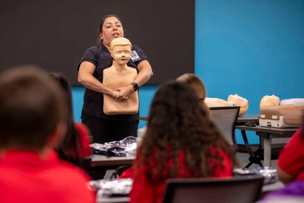 R.N. Xochitl Kambak teaches campers how to help someone who is choking during UNLV School of Nu ...