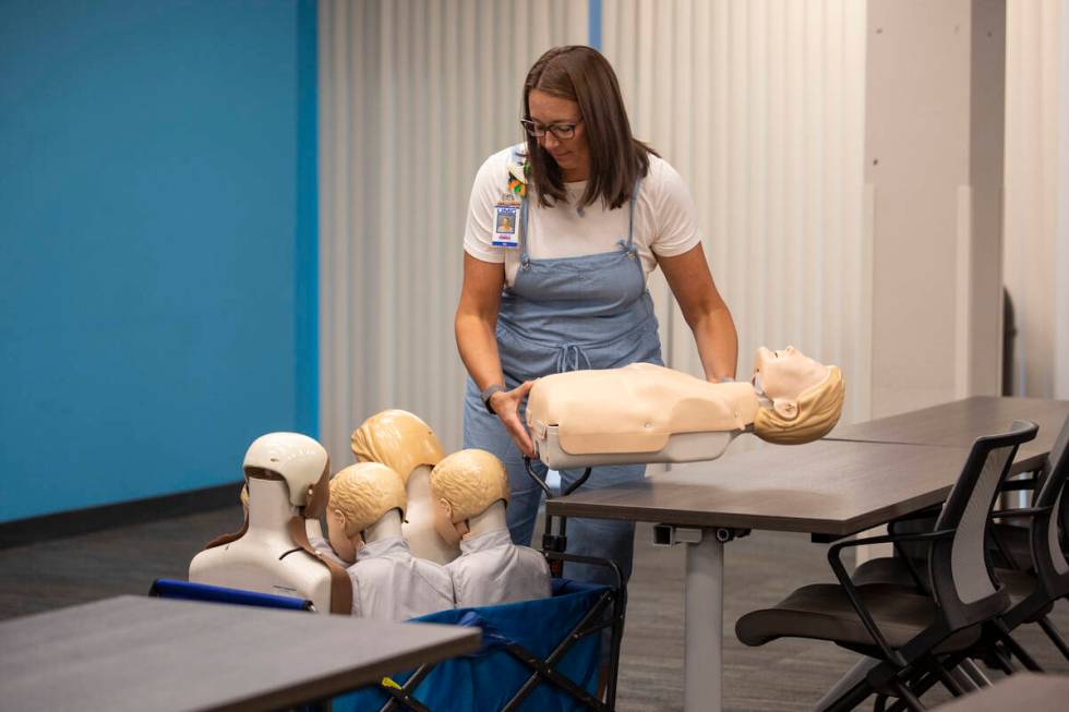 R.N. Jamie Hurley loads a cart with CPR mannequins during UNLV School of Nursing's 5th annual N ...