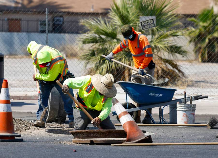 Jose Gonzales, left, Harold Arnold, center, and Manny Venegas, all from Las Vegas Paving, prepa ...