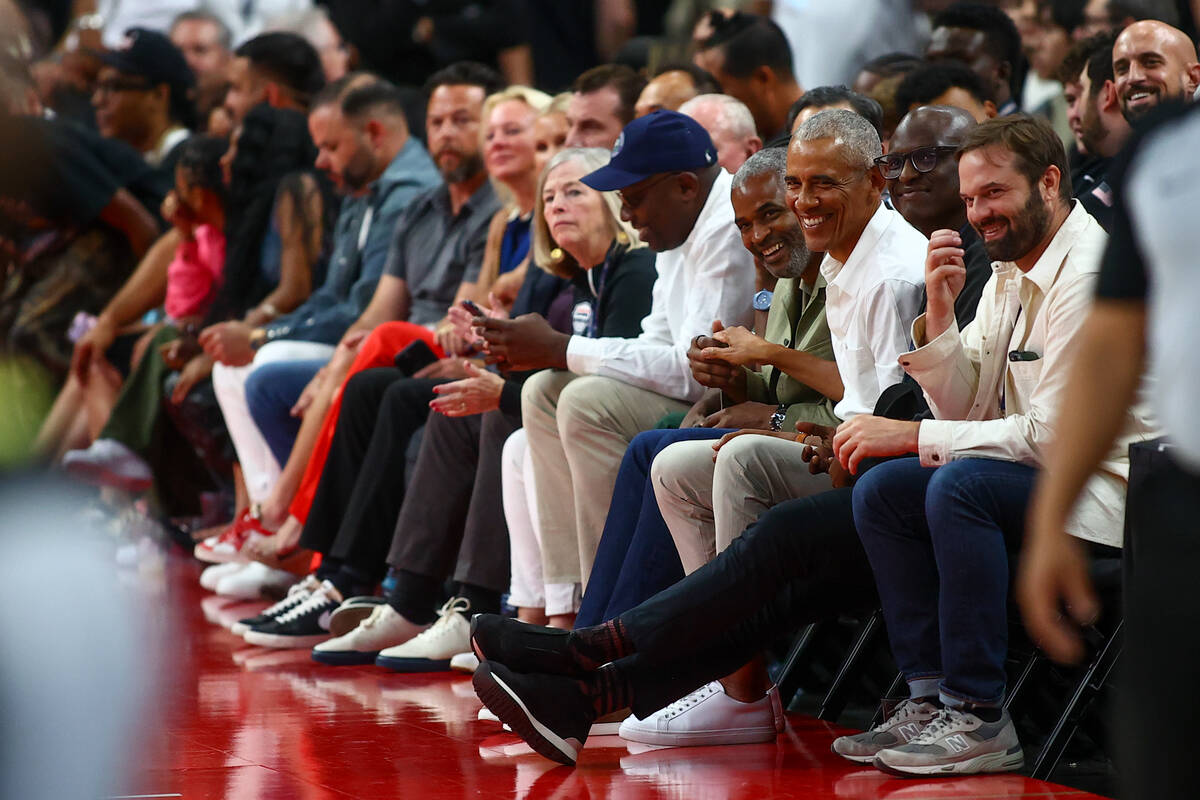 President Barack Obama sits court side during the first half of a showcase basketball game betw ...