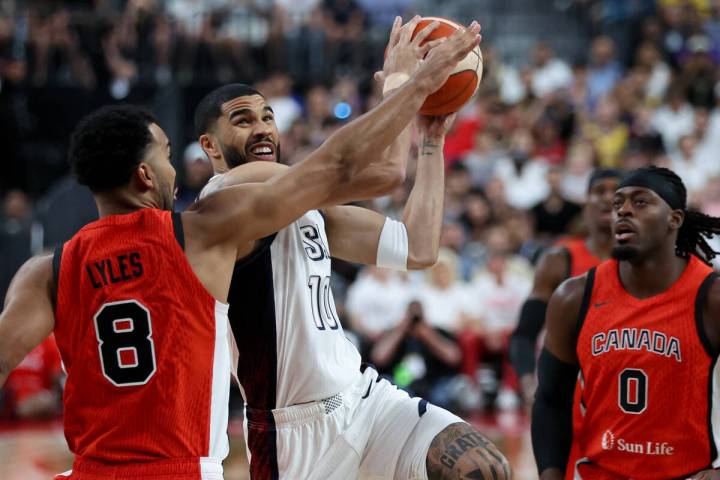 USA forward Jayson Tatum (10) drives toward the hoop against Canada forward Trey Lyles (8) duri ...