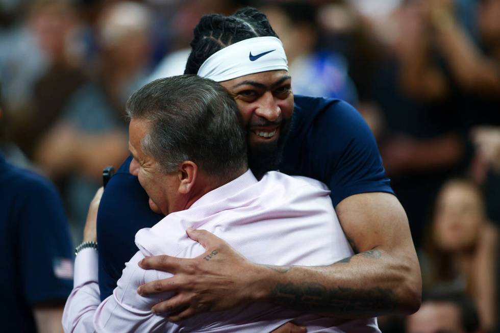 USA forward Anthony Davis embraces former coach John Calipari during a showcase basketball game ...
