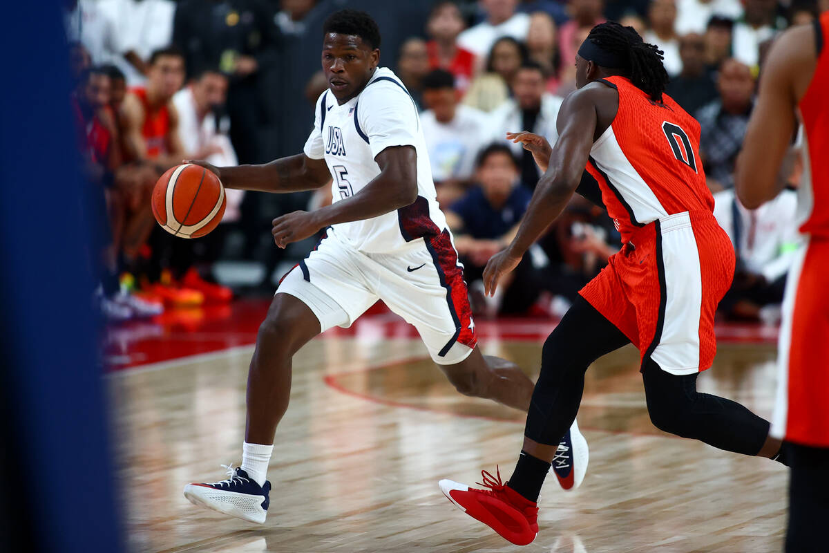 USA guard Anthony Edwards (5) dribbles up the court against Canada guard Luguentz Dort (0) duri ...
