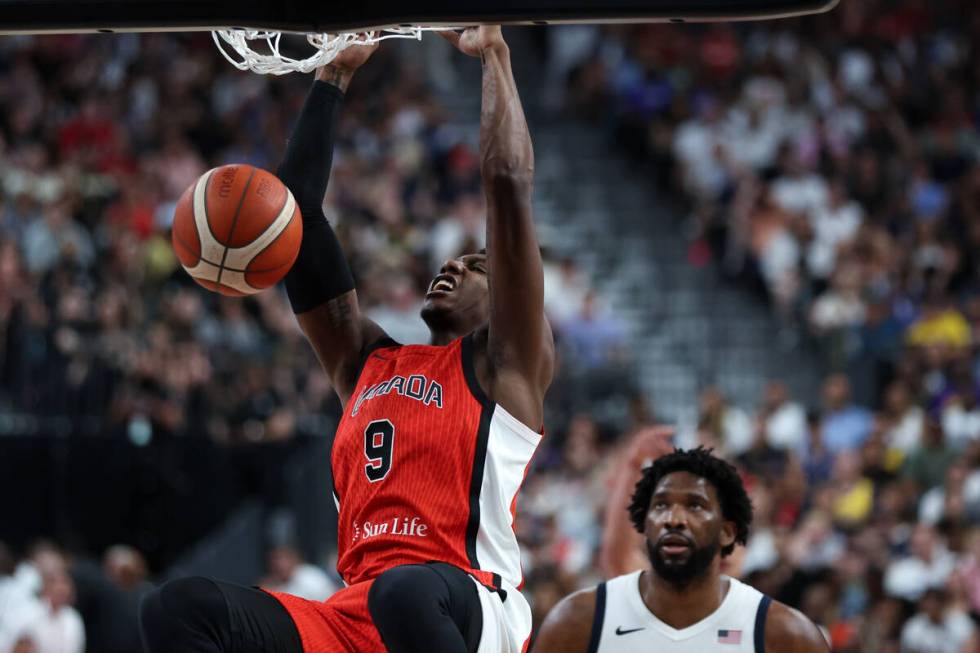 Canada guard RJ Barrett (9) dunks while USA center Joel Embiid (11) looks on during the second ...