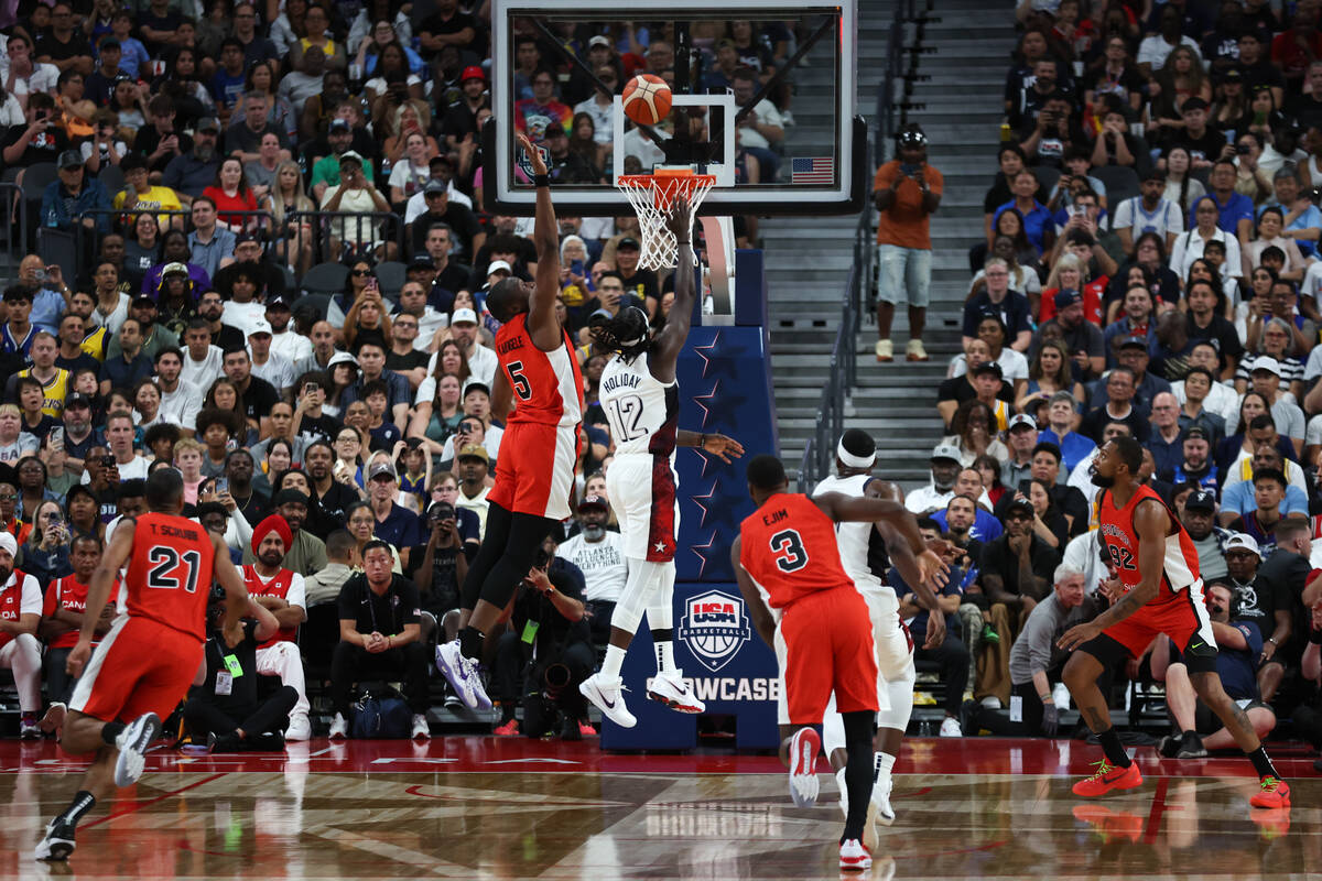 USA guard Jrue Holiday (12) scores against Canada center Mfiondu Kabengele (5) during the secon ...