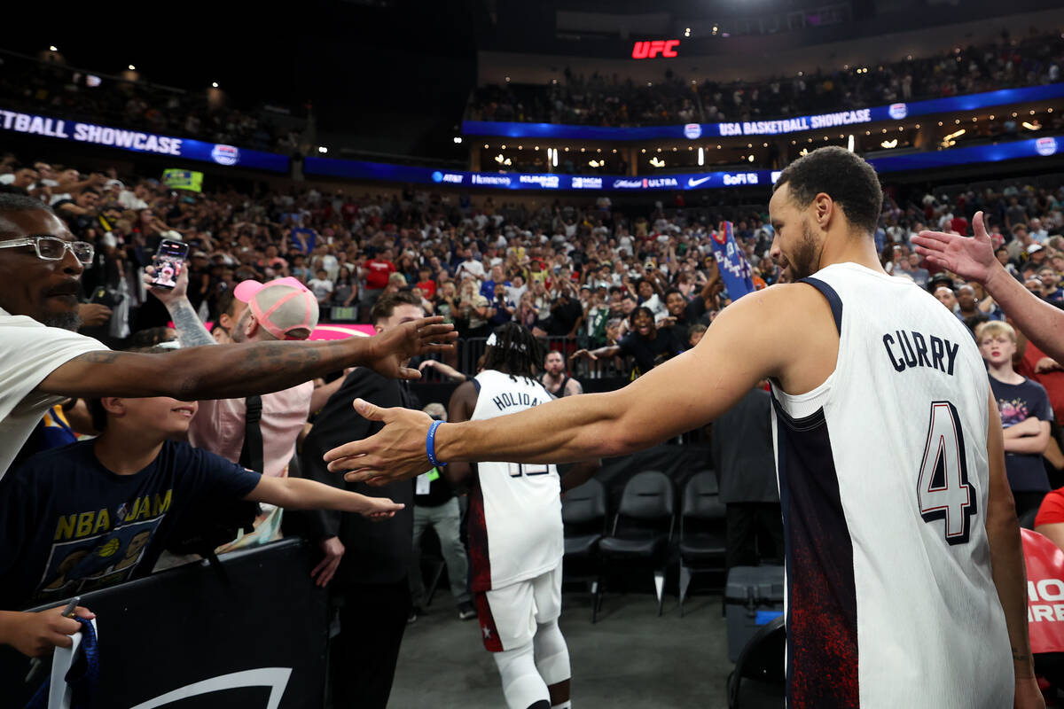 USA guard Stephen Curry (4) high-fives fans after his team won a showcase basketball game again ...