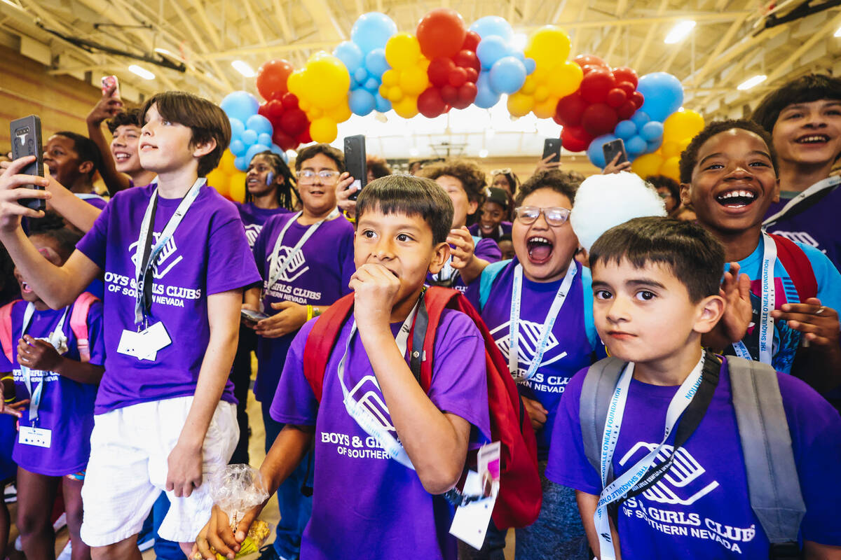 Members of the Boys & Girls Club react to seeing Shaquille O’Neal walking towards th ...