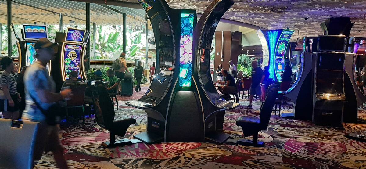 Mirage guests wait to play the limited number of operational slot machines during the property' ...
